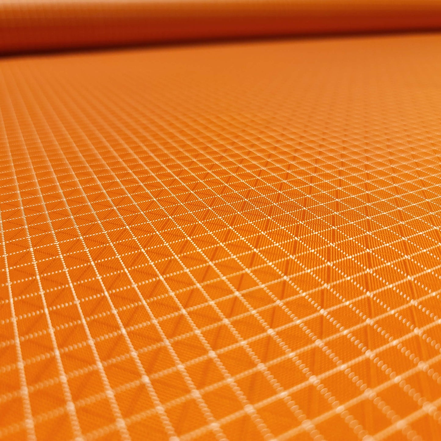 High-quality image showcasing my Carrot Orange 210D UHMWPE Gridstop Nylon fabric, emphasizing its lightweight, durable woven texture and unique waterproof properties. The image highlights the fabric's intricate UHMWPE fiber grid, its robust 210D denier thickness, and the dual protective coating – 1000mm PU on the back and DWR on the front. Ideal for visualizing the fabric's application in making resilient, weather-resistant outdoor gear like backpacks, fanny packs, and reinforcement areas.