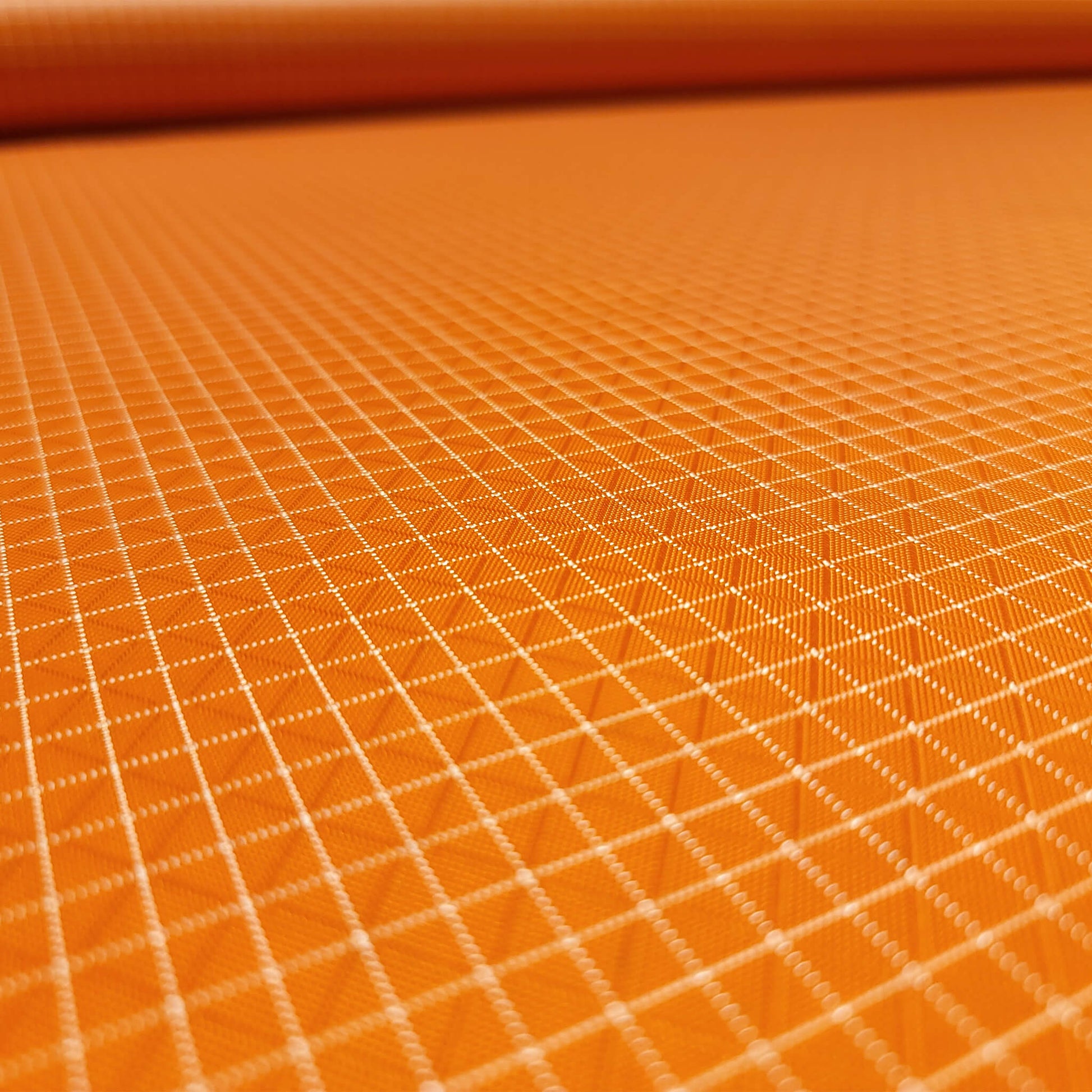 High-quality image showcasing my Carrot Orange 210D UHMWPE Gridstop Nylon fabric, emphasizing its lightweight, durable woven texture and unique waterproof properties. The image highlights the fabric's intricate UHMWPE fiber grid, its robust 210D denier thickness, and the dual protective coating – 1000mm PU on the back and DWR on the front. Ideal for visualizing the fabric's application in making resilient, weather-resistant outdoor gear like backpacks, fanny packs, and reinforcement areas.