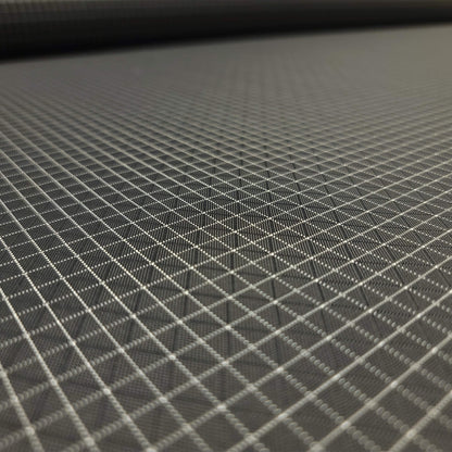 High-quality image showcasing my Charcoal Grey 210D UHMWPE Gridstop Nylon fabric, emphasizing its lightweight, durable woven texture and unique waterproof properties. The image highlights the fabric's intricate UHMWPE fiber grid, its robust 210D denier thickness, and the dual protective coating – 1000mm PU on the back and DWR on the front. Ideal for visualizing the fabric's application in making resilient, weather-resistant outdoor gear like backpacks, fanny packs, and reinforcement areas.