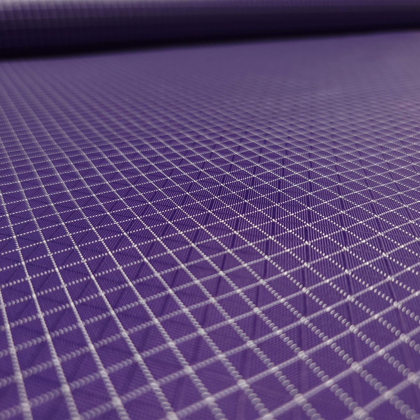 High-quality image showcasing my Grape Purple 210D UHMWPE Gridstop Nylon fabric, emphasizing its lightweight, durable woven texture and unique waterproof properties. The image highlights the fabric's intricate UHMWPE fiber grid, its robust 210D denier thickness, and the dual protective coating – 1000mm PU on the back and DWR on the front. Ideal for visualizing the fabric's application in making resilient, weather-resistant outdoor gear like backpacks, fanny packs, and reinforcement areas.