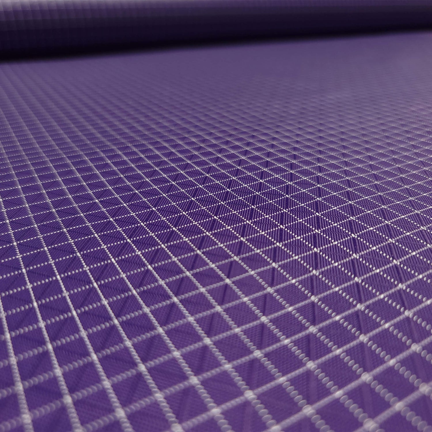 High-quality image showcasing my Grape Purple 210D UHMWPE Gridstop Nylon fabric, emphasizing its lightweight, durable woven texture and unique waterproof properties. The image highlights the fabric's intricate UHMWPE fiber grid, its robust 210D denier thickness, and the dual protective coating – 1000mm PU on the back and DWR on the front. Ideal for visualizing the fabric's application in making resilient, weather-resistant outdoor gear like backpacks, fanny packs, and reinforcement areas.