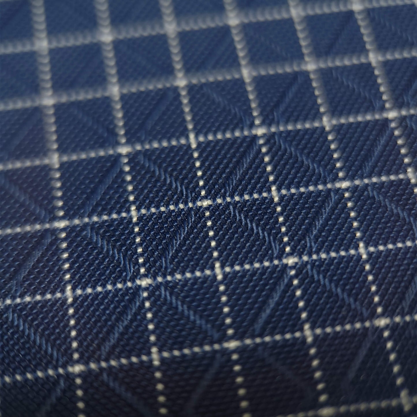 High-quality image showcasing my Midnight Navy 210D UHMWPE Gridstop Nylon fabric, emphasizing its lightweight, durable woven texture and unique waterproof properties. The image highlights the fabric's intricate UHMWPE fiber grid, its robust 210D denier thickness, and the dual protective coating – 1000mm PU on the back and DWR on the front. Ideal for visualizing the fabric's application in making resilient, weather-resistant outdoor gear like backpacks, fanny packs, and reinforcement areas.