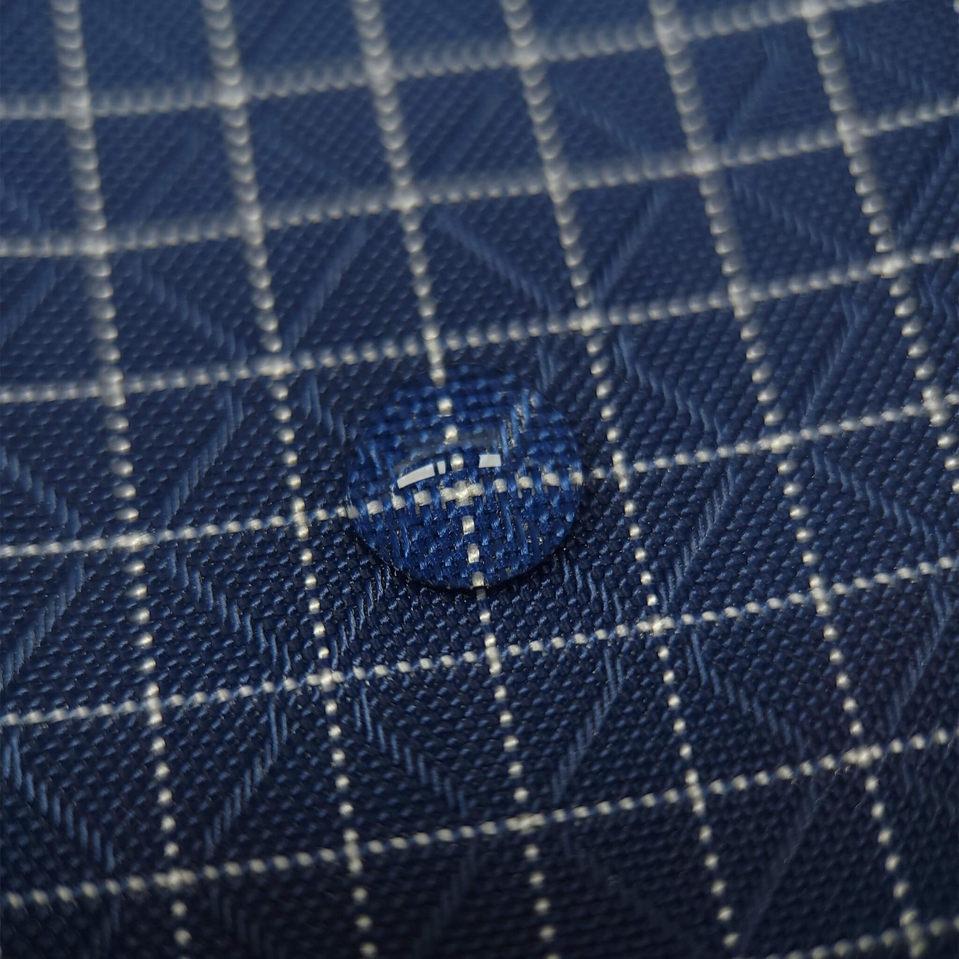 High-quality image showcasing my Midnight Navy 210D UHMWPE Gridstop Nylon fabric, emphasizing its lightweight, durable woven texture and unique waterproof properties. The image highlights the fabric's intricate UHMWPE fiber grid, its robust 210D denier thickness, and the dual protective coating – 1000mm PU on the back and DWR on the front. Ideal for visualizing the fabric's application in making resilient, weather-resistant outdoor gear like backpacks, fanny packs, and reinforcement areas.