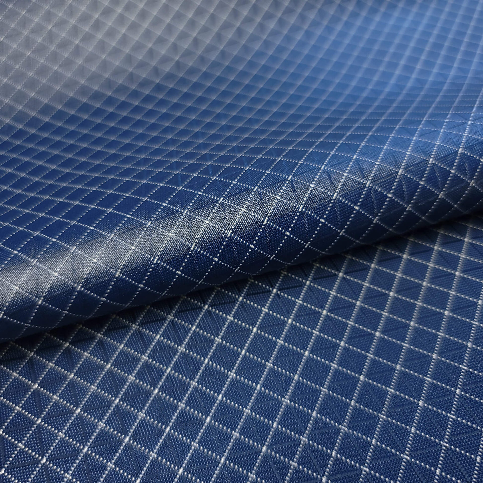 High-quality image showcasing my Midnight Navy 210D UHMWPE Gridstop Nylon fabric, emphasizing its lightweight, durable woven texture and unique waterproof properties. The image highlights the fabric's intricate UHMWPE fiber grid, its robust 210D denier thickness, and the dual protective coating – 1000mm PU on the back and DWR on the front. Ideal for visualizing the fabric's application in making resilient, weather-resistant outdoor gear like backpacks, fanny packs, and reinforcement areas.