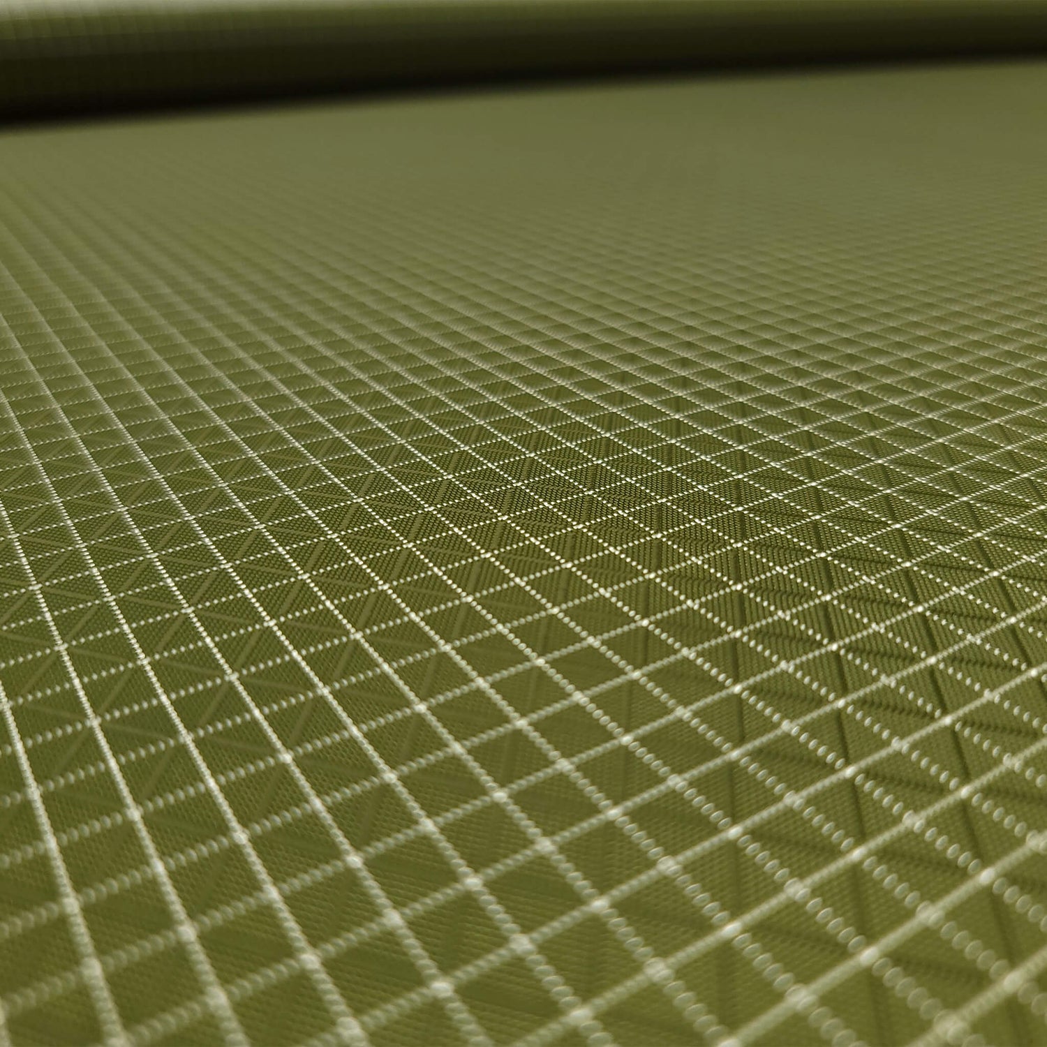 High-quality image showcasing my Olive Green 210D UHMWPE Gridstop Nylon fabric, emphasizing its lightweight, durable woven texture and unique waterproof properties. The image highlights the fabric's intricate UHMWPE fiber grid, its robust 210D denier thickness, and the dual protective coating – 1000mm PU on the back and DWR on the front. Ideal for visualizing the fabric's application in making resilient, weather-resistant outdoor gear like backpacks, fanny packs, and reinforcement areas.