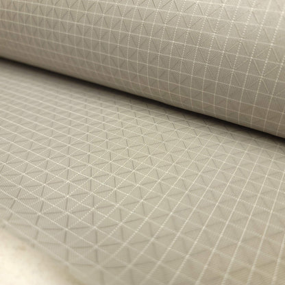 High-quality image showcasing my Stone Grey 210D UHMWPE Gridstop Nylon fabric, emphasizing its lightweight, durable woven texture and unique waterproof properties. The image highlights the fabric's intricate UHMWPE fiber grid, its robust 210D denier thickness, and the dual protective coating – 1000mm PU on the back and DWR on the front. Ideal for visualizing the fabric's application in making resilient, weather-resistant outdoor gear like backpacks, fanny packs, and reinforcement areas.