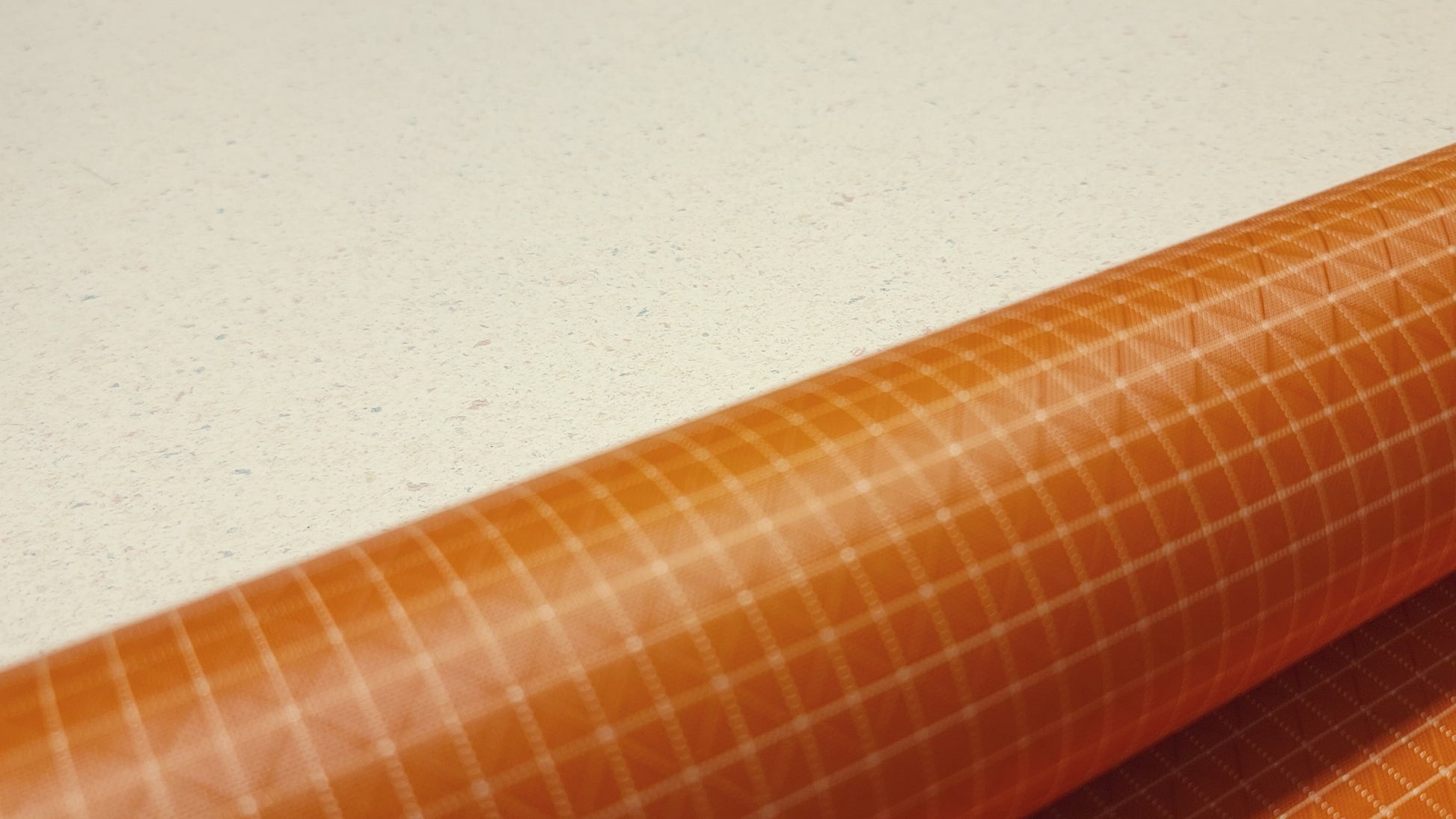 High-quality video showcasing my Carrot Orange 210D UHMWPE Gridstop Nylon fabric, emphasizing its lightweight, durable woven texture and unique waterproof properties. The video highlights the fabric's intricate UHMWPE fiber grid, its robust 210D denier thickness, and the dual protective coating – 1000mm PU on the back and DWR on the front. Ideal for visualizing the fabric's application in making resilient, weather-resistant outdoor gear like backpacks, fanny packs, and reinforcement areas.