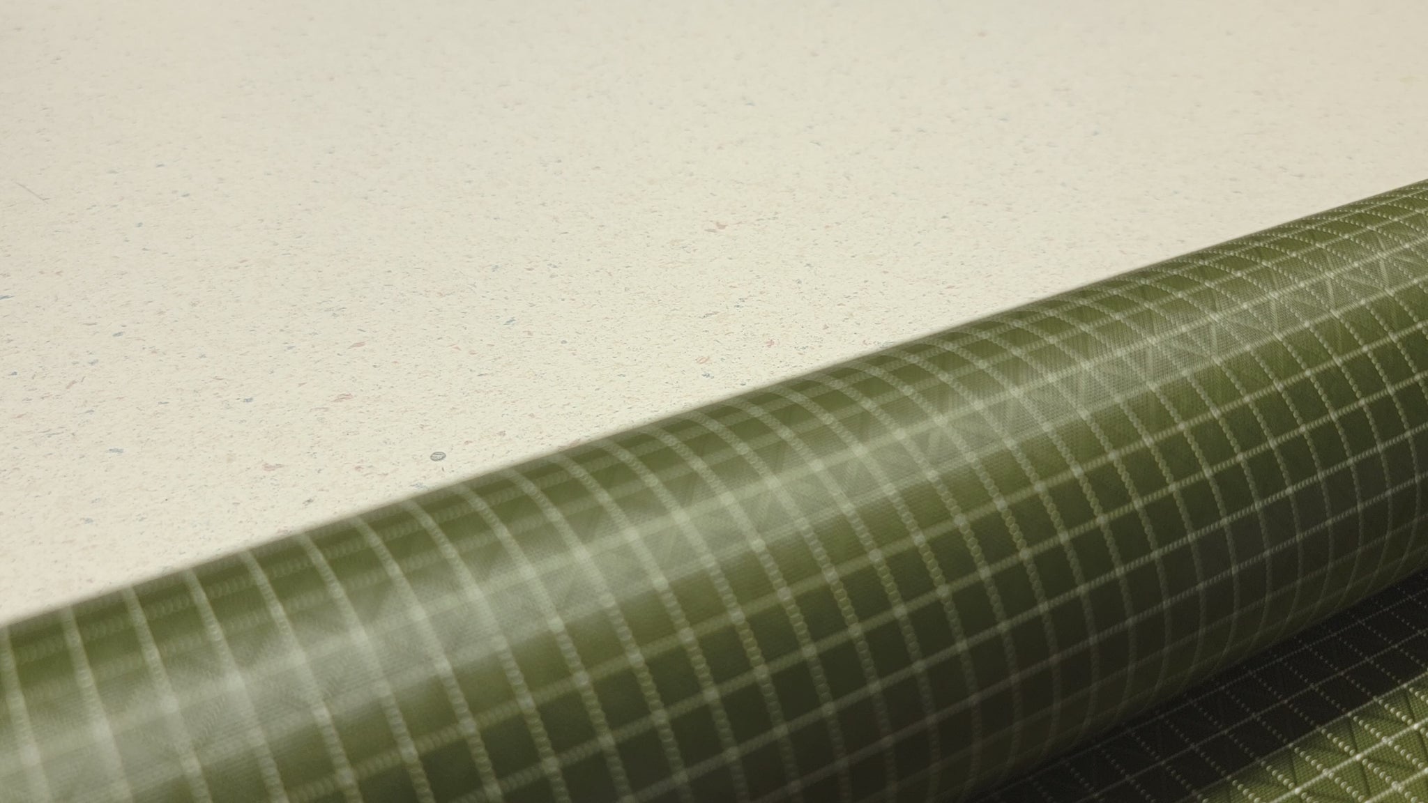 High-quality video showcasing my Olive Green 210D UHMWPE Gridstop Nylon fabric, emphasizing its lightweight, durable woven texture and unique waterproof properties. The video highlights the fabric's intricate UHMWPE fiber grid, its robust 210D denier thickness, and the dual protective coating – 1000mm PU on the back and DWR on the front. Ideal for visualizing the fabric's application in making resilient, weather-resistant outdoor gear like backpacks, fanny packs, and reinforcement areas.