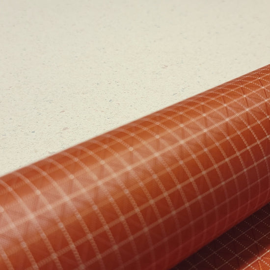 High-quality video showcasing my Mars Orange 210D UHMWPE Gridstop Nylon fabric, emphasizing its lightweight, durable woven texture and unique waterproof properties. The video highlights the fabric's intricate UHMWPE fiber grid, its robust 210D denier thickness, and the dual protective coating – 1000mm PU on the back and DWR on the front. Ideal for visualizing the fabric's application in making resilient, weather-resistant outdoor gear like backpacks, fanny packs, and reinforcement areas.