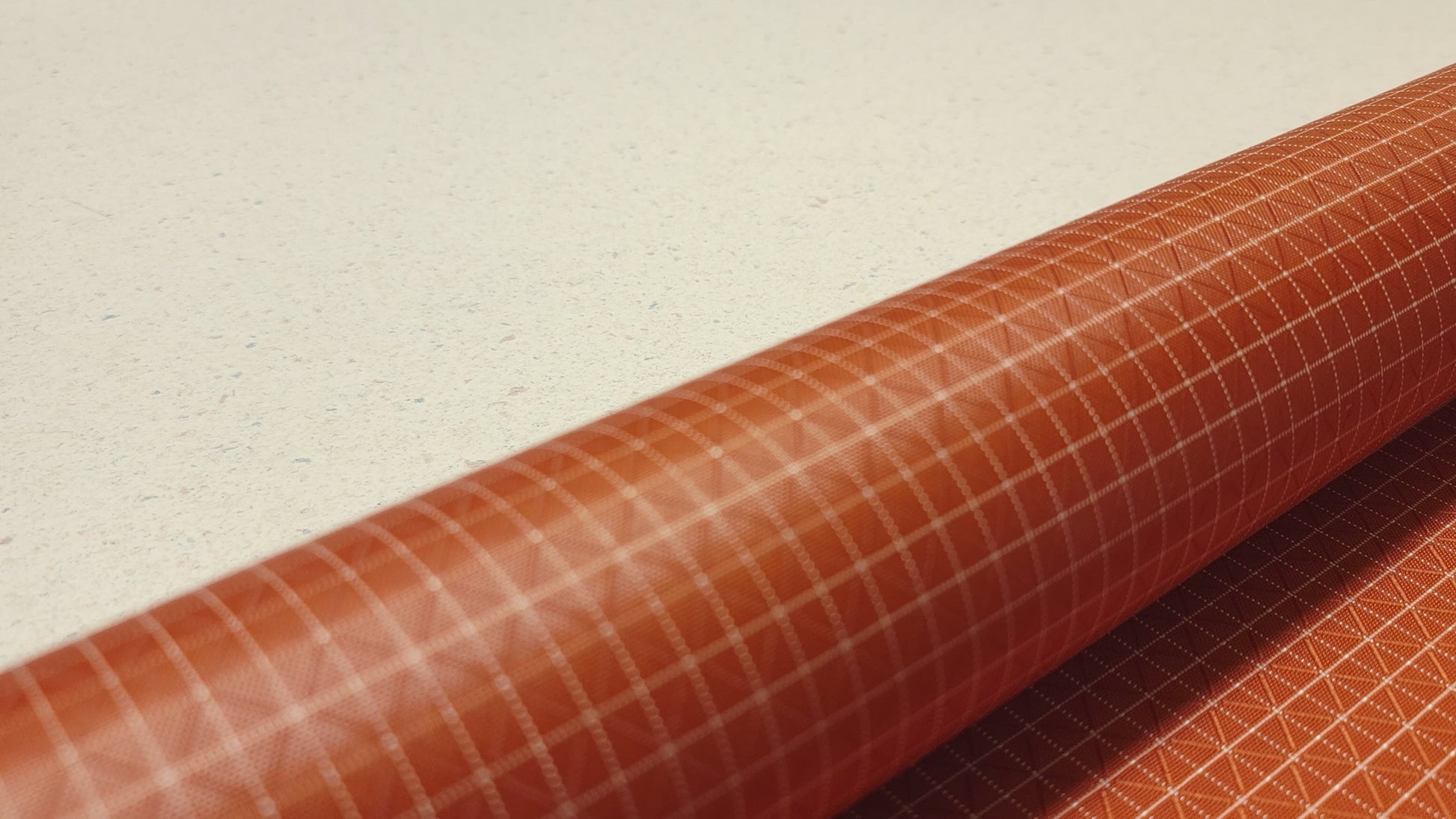 High-quality video showcasing my Mars Orange 210D UHMWPE Gridstop Nylon fabric, emphasizing its lightweight, durable woven texture and unique waterproof properties. The video highlights the fabric's intricate UHMWPE fiber grid, its robust 210D denier thickness, and the dual protective coating – 1000mm PU on the back and DWR on the front. Ideal for visualizing the fabric's application in making resilient, weather-resistant outdoor gear like backpacks, fanny packs, and reinforcement areas.